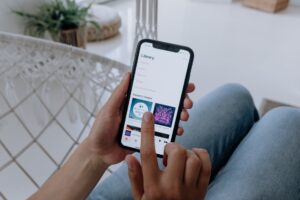 Hands holding smartphone with audio app