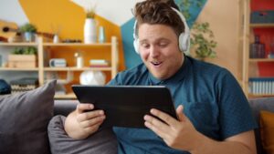 Person wearing headphones while watching TV